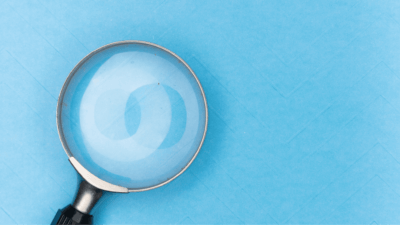 Magnifying glass on a sky blue background