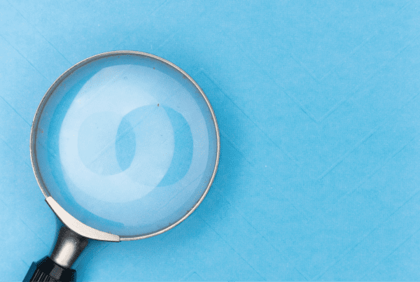 Magnifying glass on a sky blue background