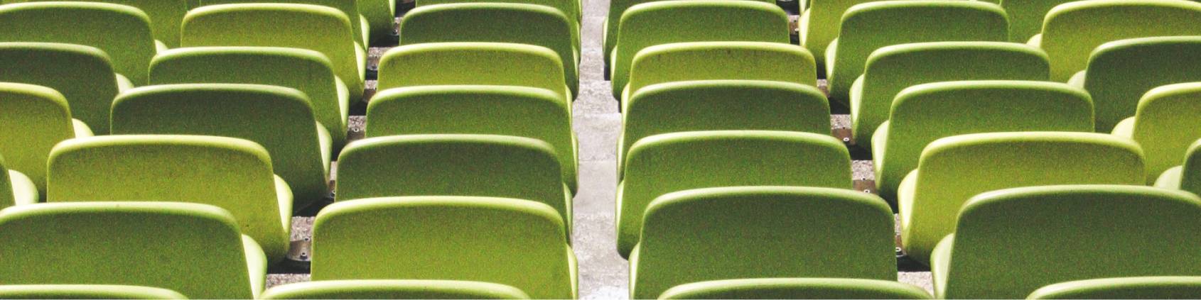 rows of empty auditorium chairs